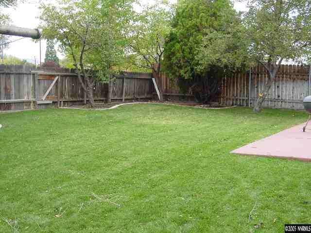 795 Bowman Drive Reno, NV 89503 - Photo 7 of 9 a view of a backyard with table and chairs and wooden fence