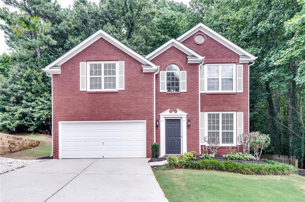 2033 Ridgestone Landing Southwest Marietta, GA 30008 - Photo 1 of 1 a front view of a house with a yard and garage