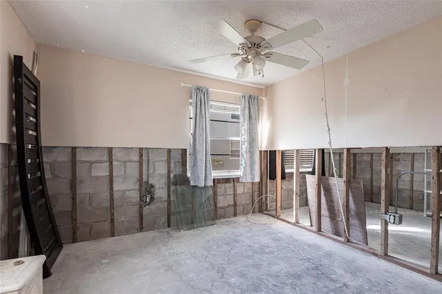 a view of a livingroom with a furniture and chandelier fan