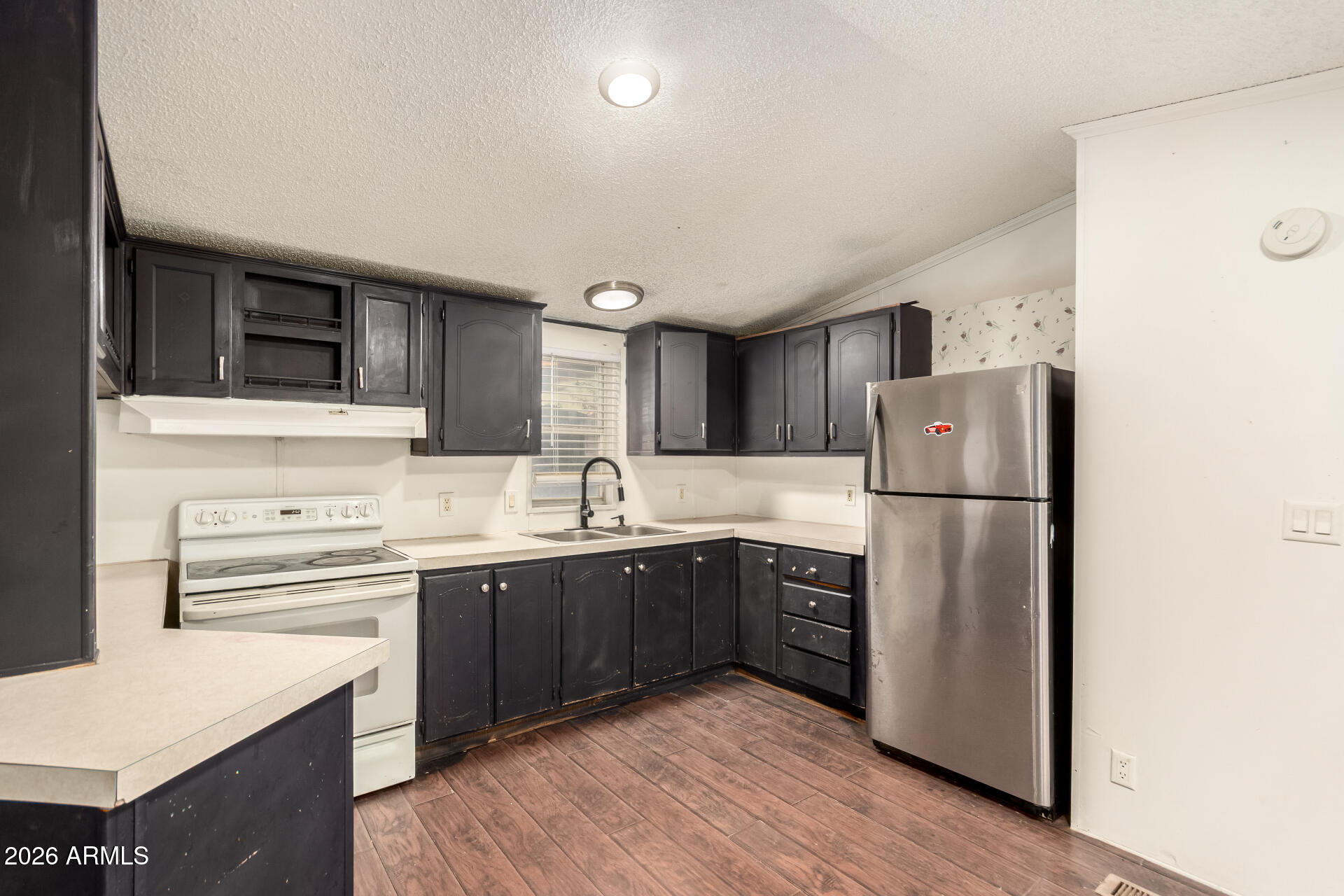 54194 West Organ Pipe Road Maricopa, AZ 85139 - Photo 16 of 52 a kitchen with stainless steel appliances a sink cabinets and wooden floor