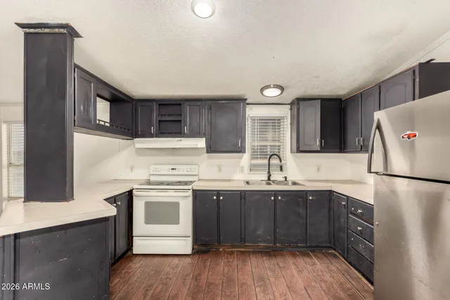 an empty room with wooden floor chandelier fan and closet area