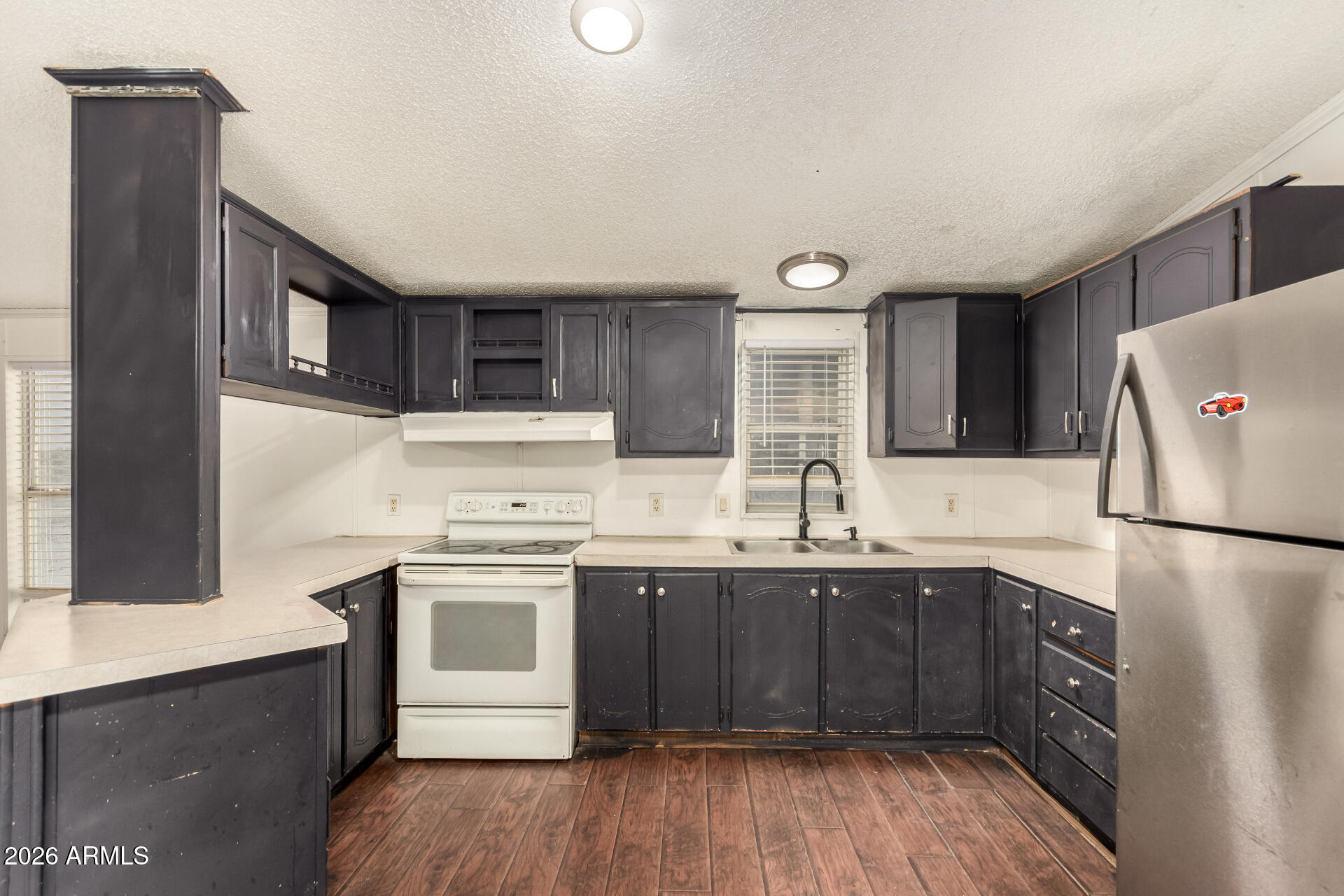 54194 West Organ Pipe Road Maricopa, AZ 85139 - Photo 17 of 52 a kitchen with a sink a stove a refrigerator and a stove