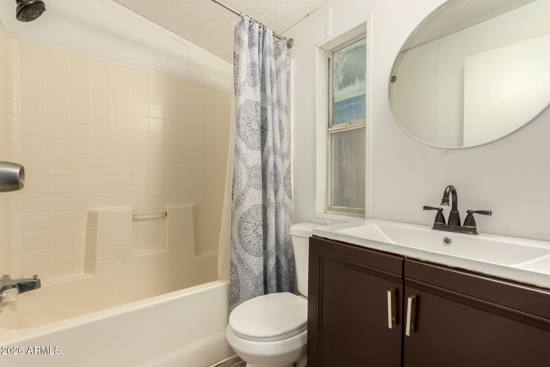 54194 West Organ Pipe Road Maricopa, AZ 85139 - Photo 27 of 52 a bathroom with a sink a toilet and a mirror