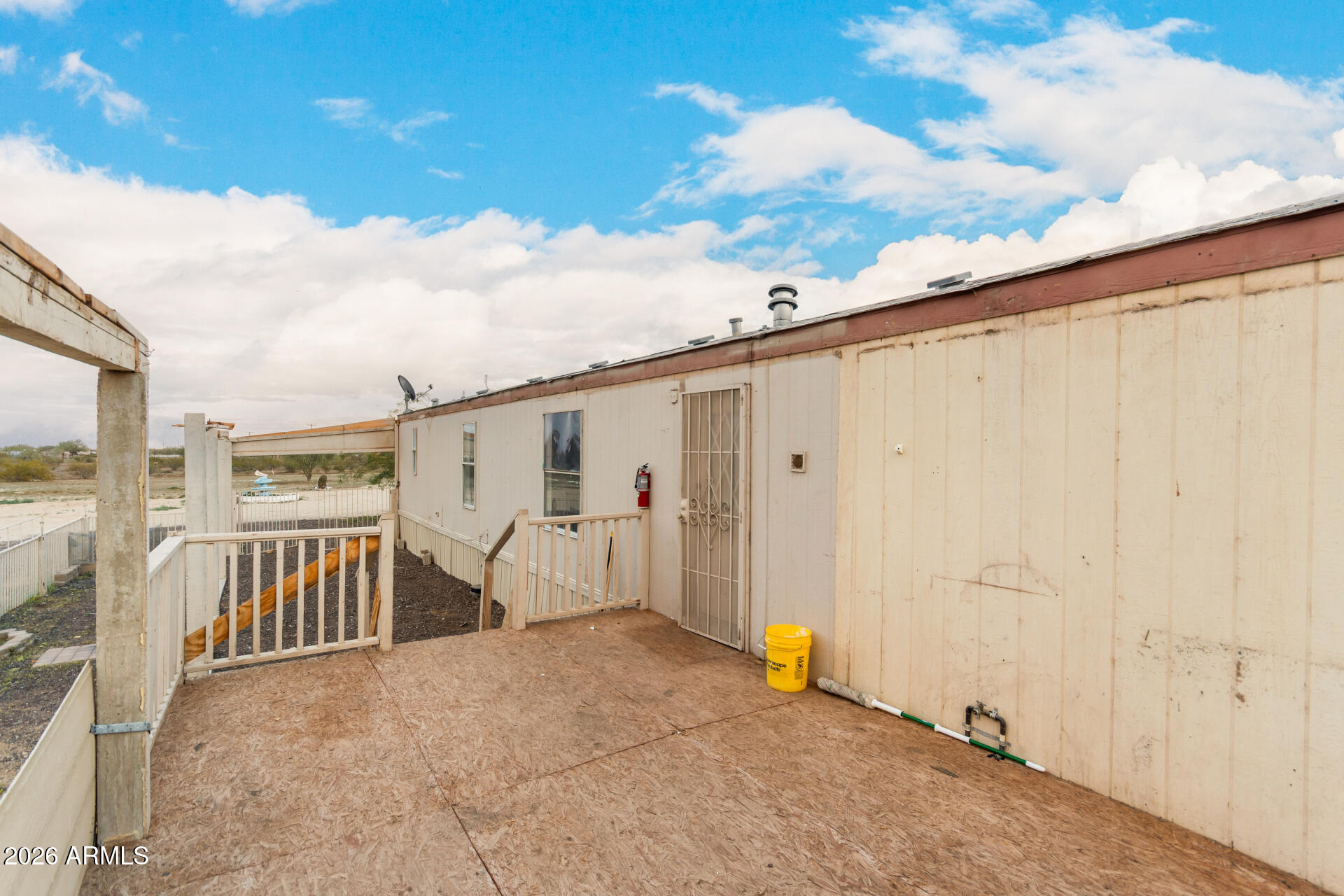 54194 West Organ Pipe Road Maricopa, AZ 85139 - Photo 29 of 52 a view of a porch with wooden floor and fence