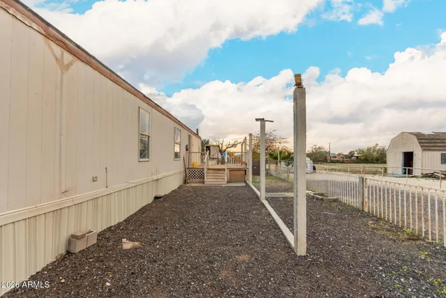 a view of a dirt road and building