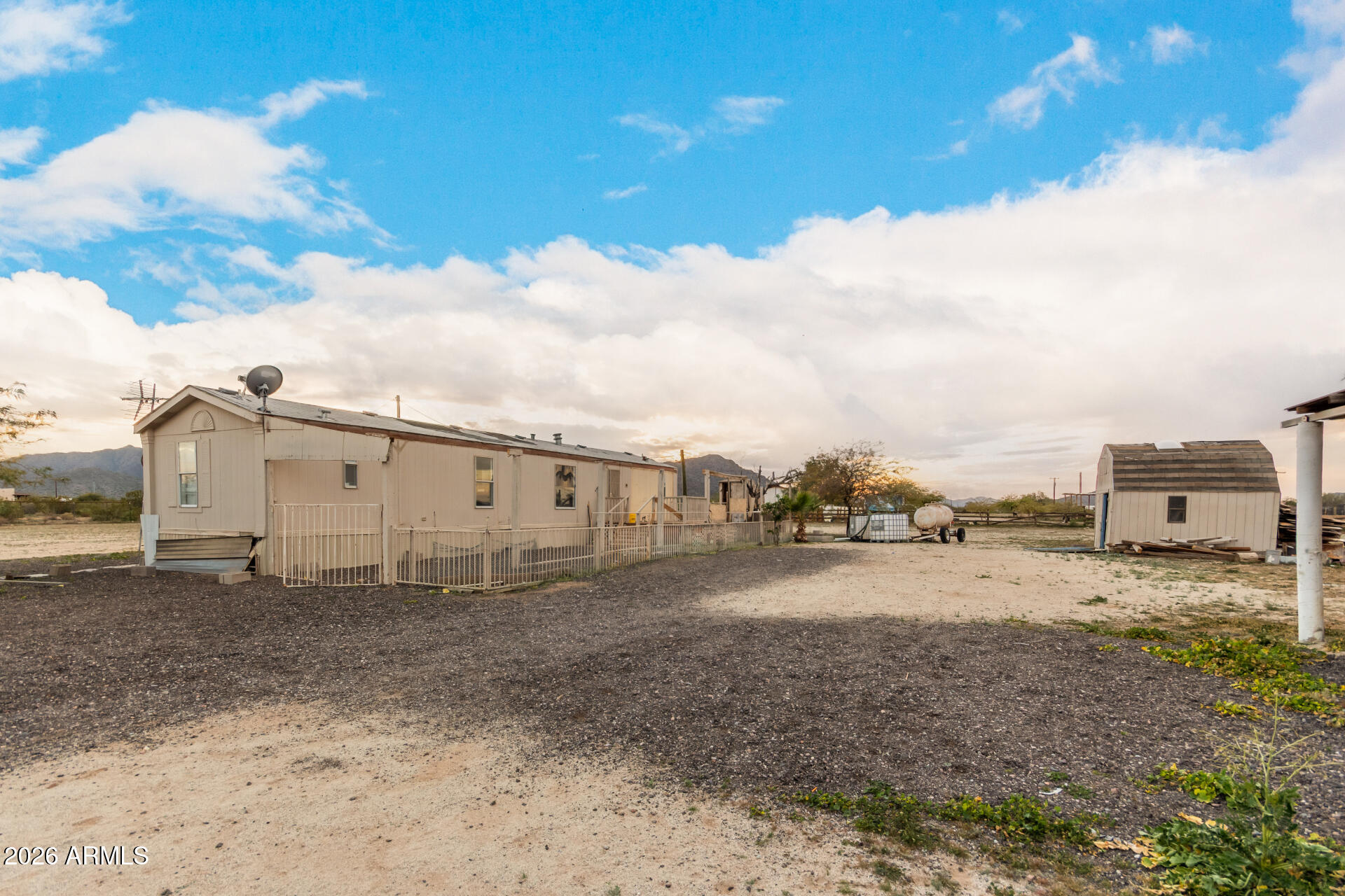 54194 West Organ Pipe Road Maricopa, AZ 85139 - Photo 36 of 52 a view of a dirt road and building
