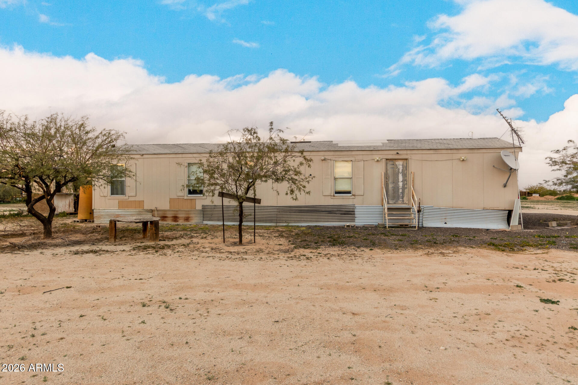 54194 West Organ Pipe Road Maricopa, AZ 85139 - Photo 8 of 52 a view of a dirt yard with a barbeque