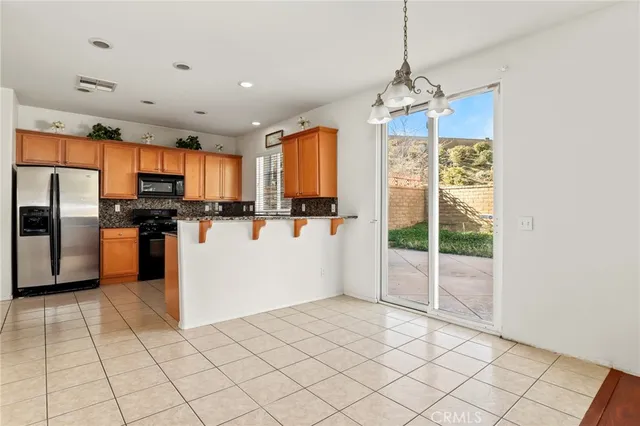 an empty room with a window and a ceiling fan