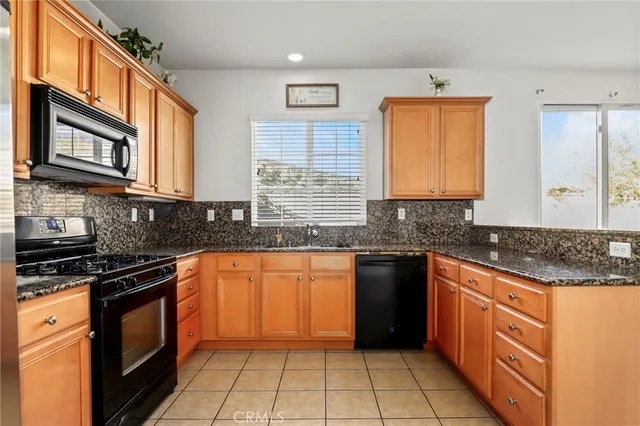 an empty room with a ceiling fan and a window