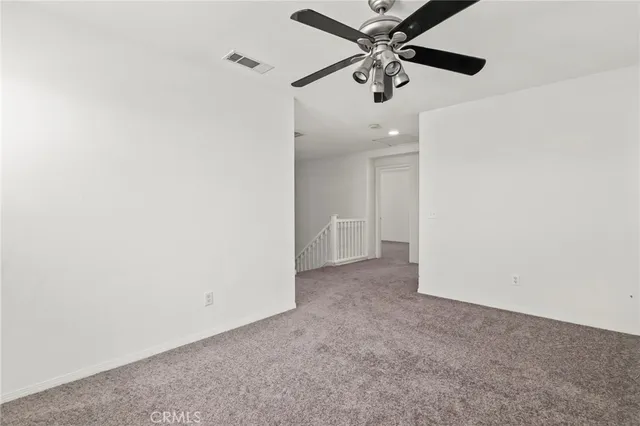 an empty room with closet and windows