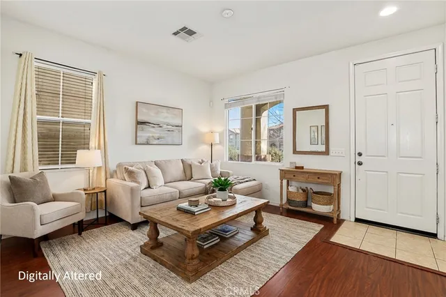 an empty room with wooden floor cabinet and windows