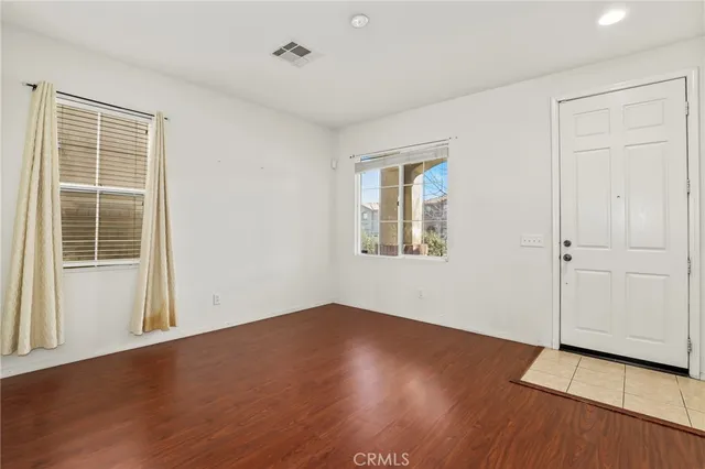 a view of a room with wooden floor