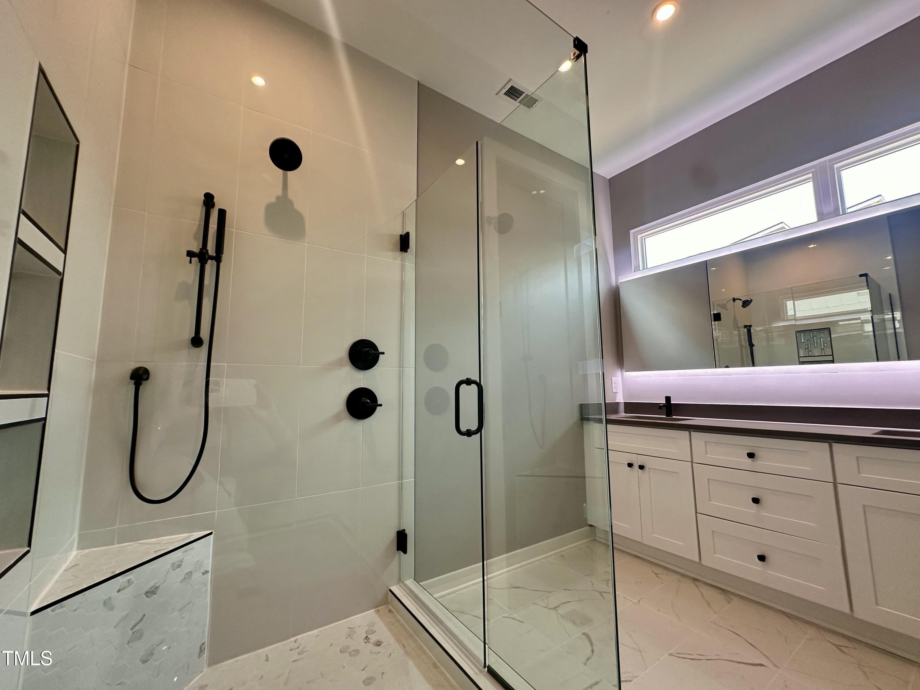 1525 Havenmont Court Raleigh, NC 27608 - Photo 11 of 40 a bathroom with a shower sink and mirror