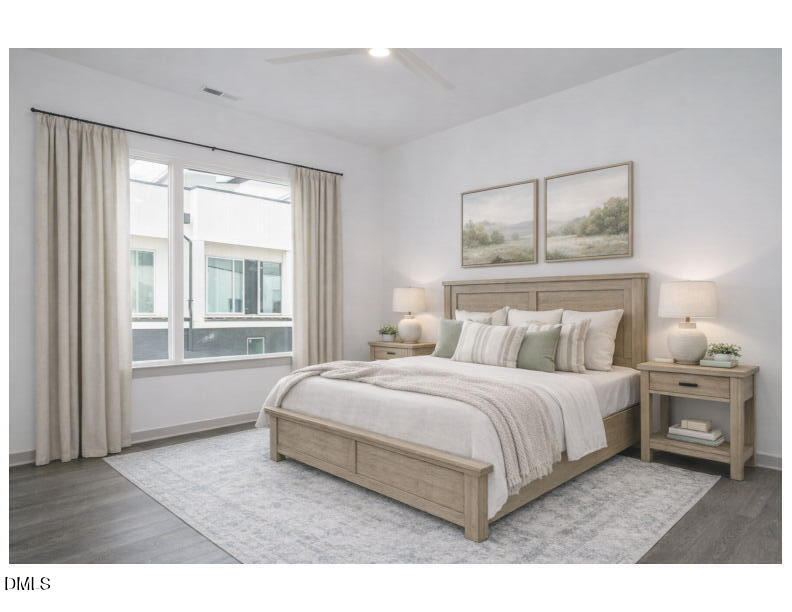 1525 Havenmont Court Raleigh, NC 27608 - Photo 9 of 40 a bedroom with a bed and wooden floor