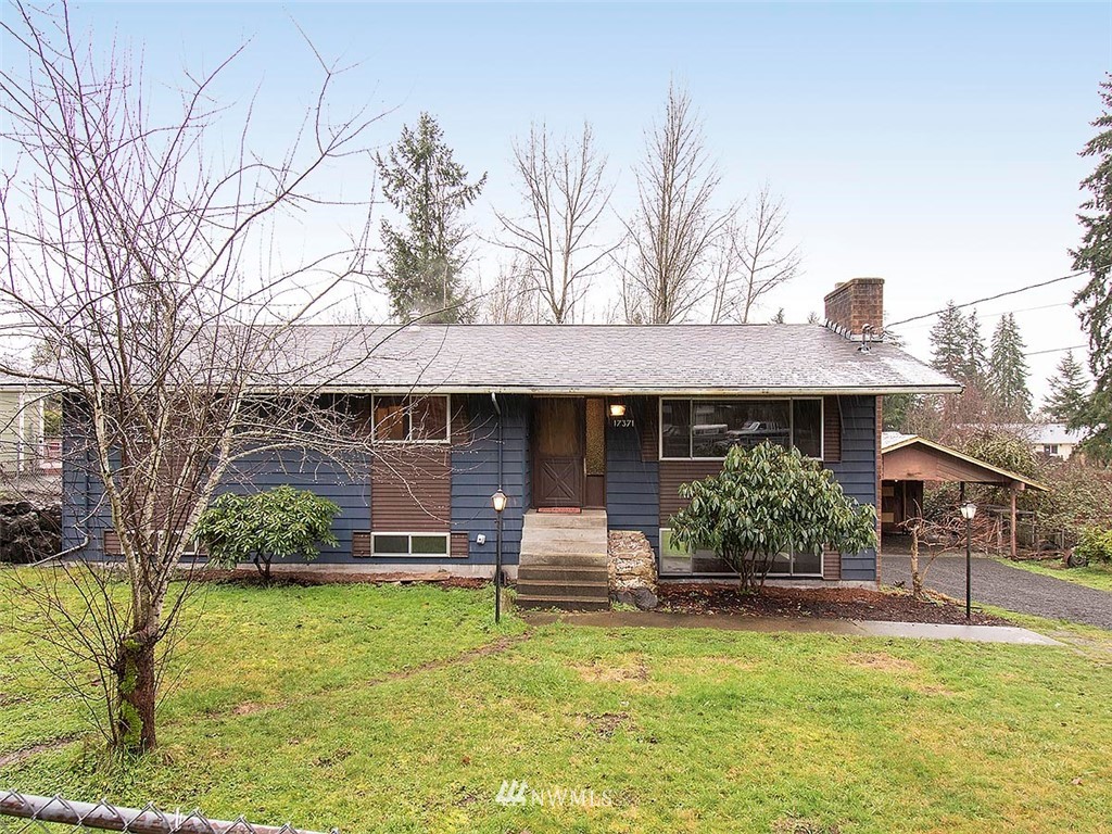 17371 Southeast 133rd Street Renton, WA 98059 - Photo 1 of 22 a front view of house with yard and trees in the background
