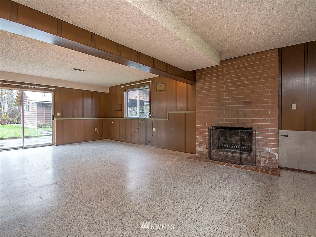 17371 Southeast 133rd Street Renton, WA 98059 - Photo 19 of 22 a view of an empty room with a fireplace and a window