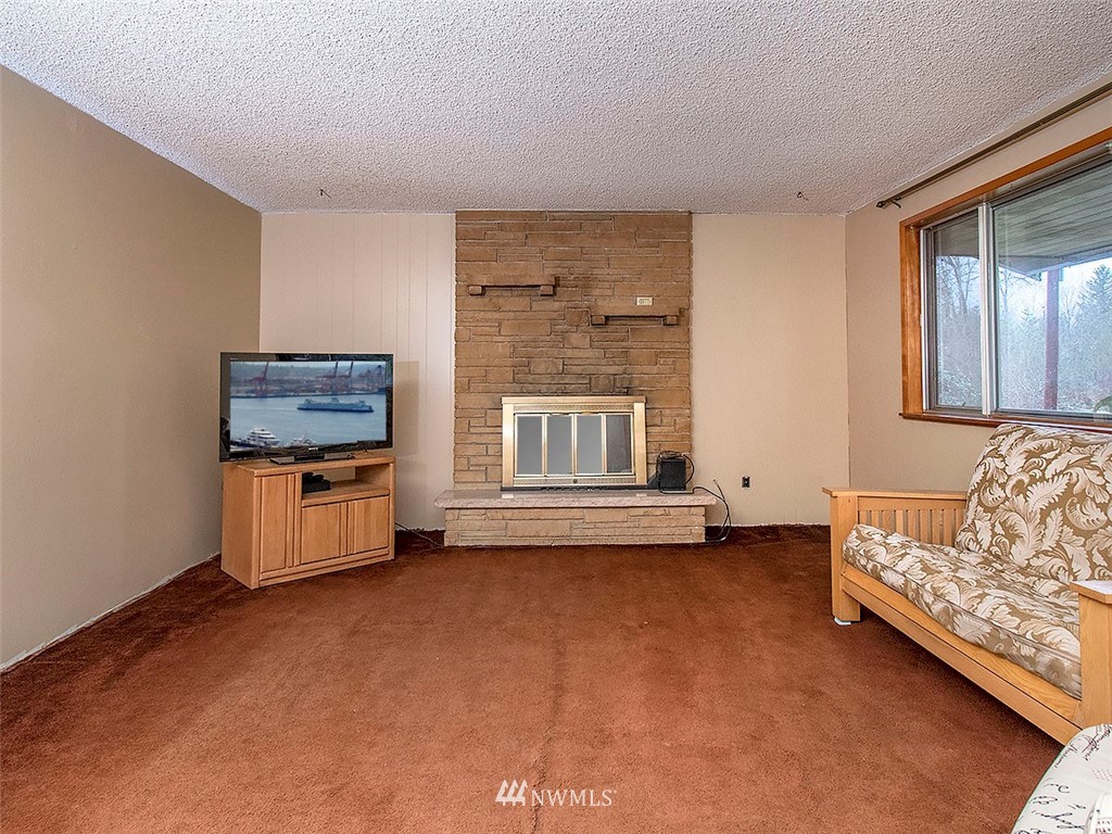 17371 Southeast 133rd Street Renton, WA 98059 - Photo 4 of 22 a living room with furniture and a flat screen tv