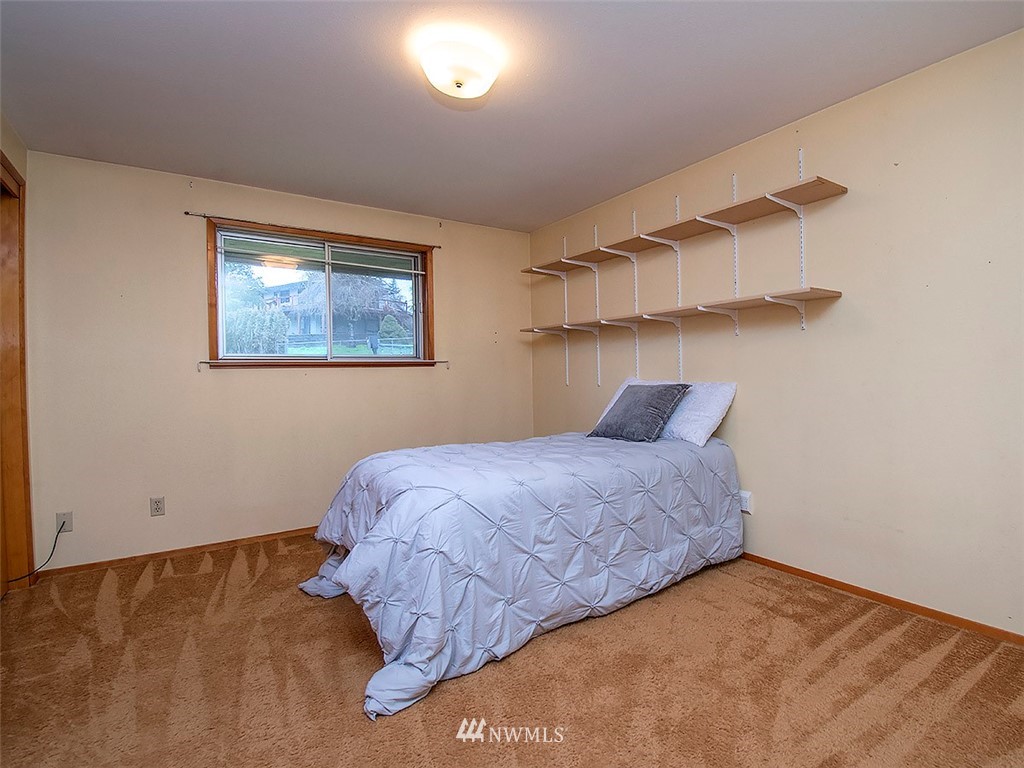 17371 Southeast 133rd Street Renton, WA 98059 - Photo 8 of 22 a bedroom with a bed and a window