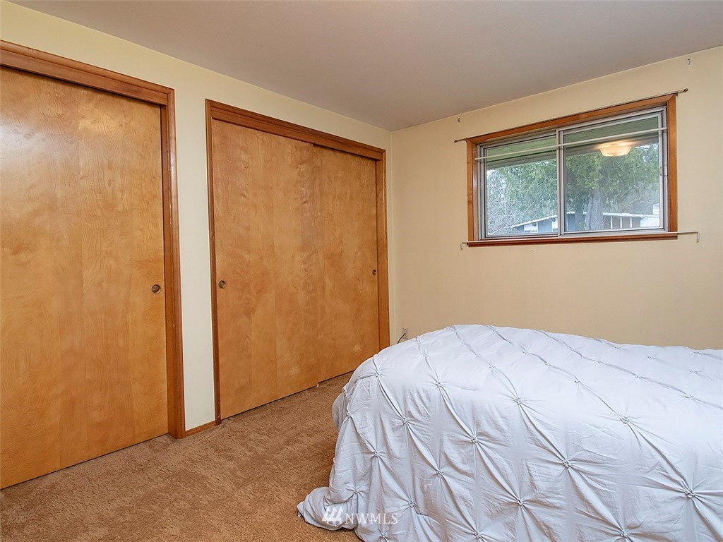 17371 Southeast 133rd Street Renton, WA 98059 - Photo 9 of 22 a bedroom with a bed and a window