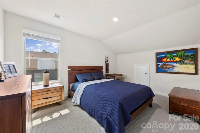 a bedroom with a bed and a couch