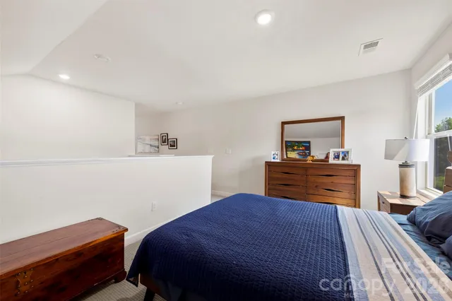 a bedroom with a bed and a dresser in it