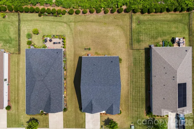 an aerial view of a house with a swimming pool and outdoor seating