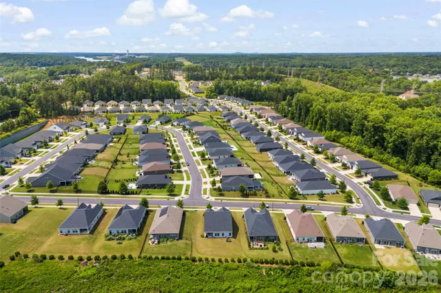an aerial view of residential houses with outdoor space and swimming pool