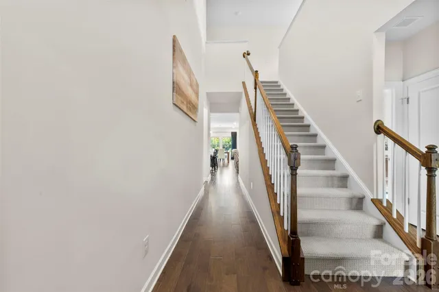a view of a hallway with wooden floor and entryway