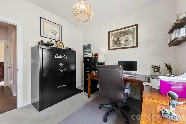 a view of a workspace with furniture and a bedroom