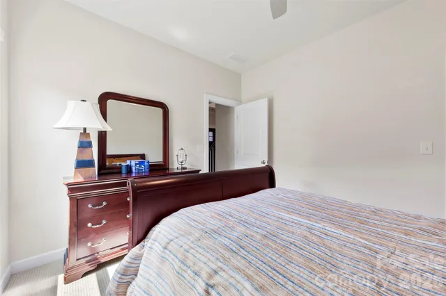 a bedroom with a bed and a mirror