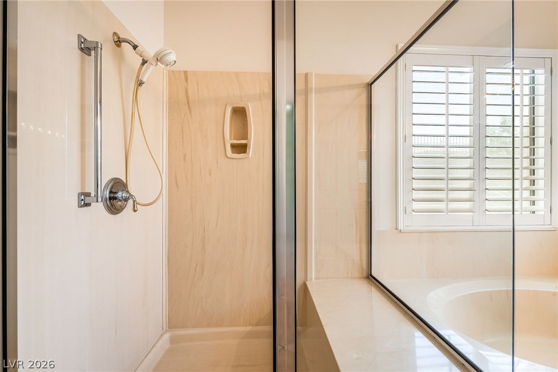 3033 Hartsville Road Henderson, NV 89052 - Photo 31 of 41 A well-appointed shower and separate soaking tub create a personal spa-like experience.