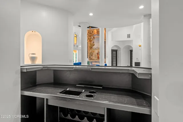 a kitchen with a sink stove and cabinets