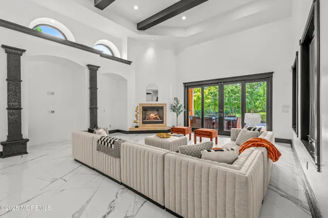 a living room with furniture and a floor to ceiling window