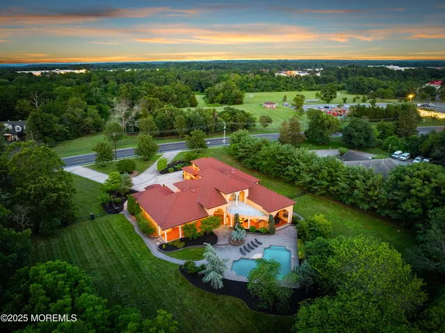 an aerial view of residential houses with outdoor space and river