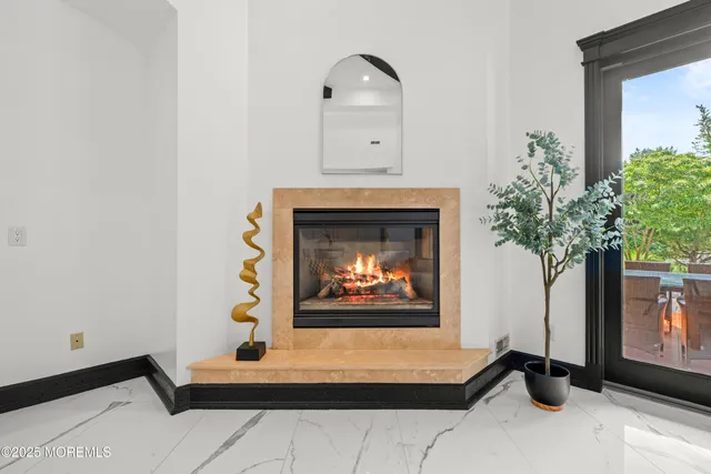 a view of an empty room with closet and a fireplace