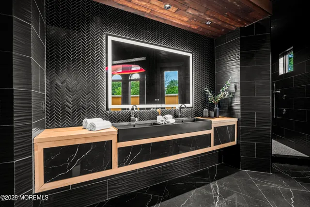 a view of a backyard with potted plants and large trees