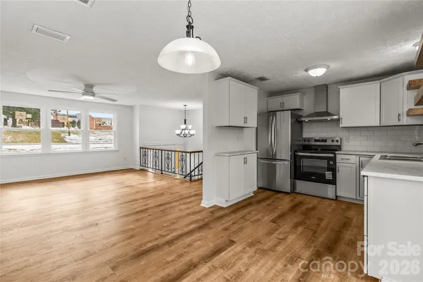 a kitchen with stainless steel appliances a refrigerator sink and stove