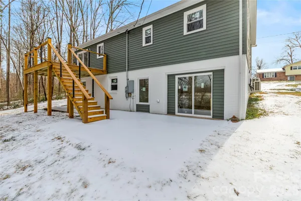 a view of a house with a snow on the road