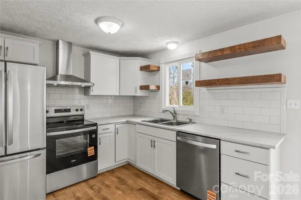 a kitchen with a sink stove and refrigerator