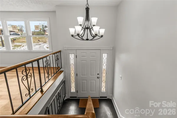 a view of staircase with wooden floor and a window