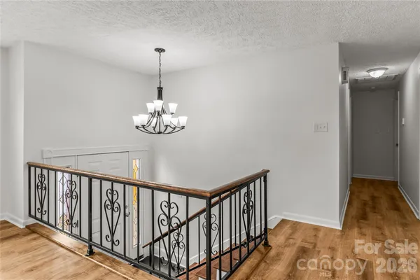 a dining room with wooden floor a chandelier and entryway