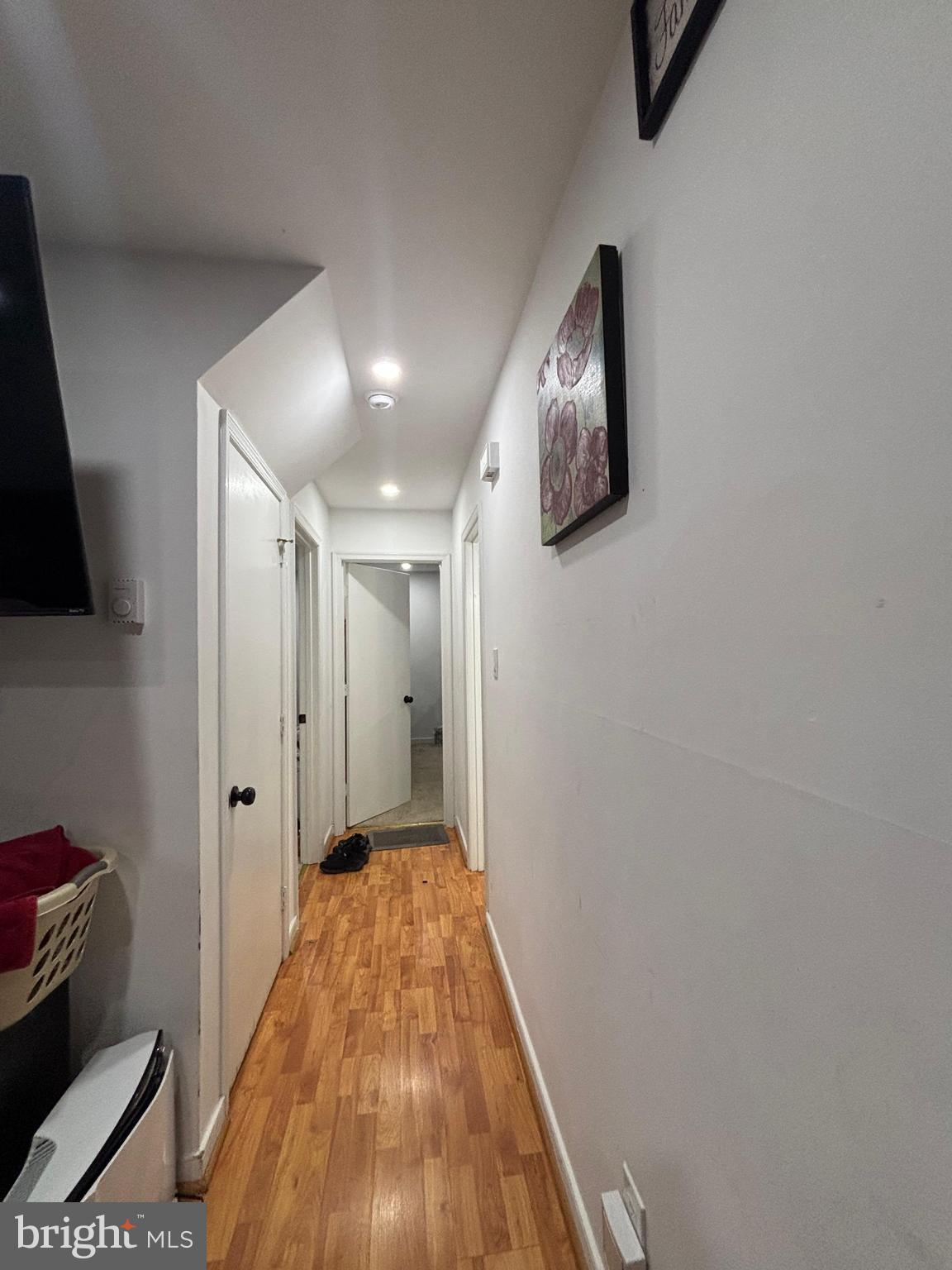6004 Simplicity Court Chesterfield, VA 23832 - Photo 8 of 17 a view of a hallway with wooden floor and a flat screen tv