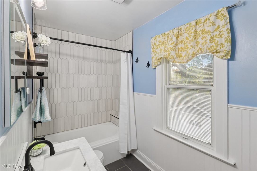2482 Princeton Road Cleveland, OH 44118 - Photo 17 of 32 Full bath with shower / bath combination with curtain, a wainscoted wall, and vanity