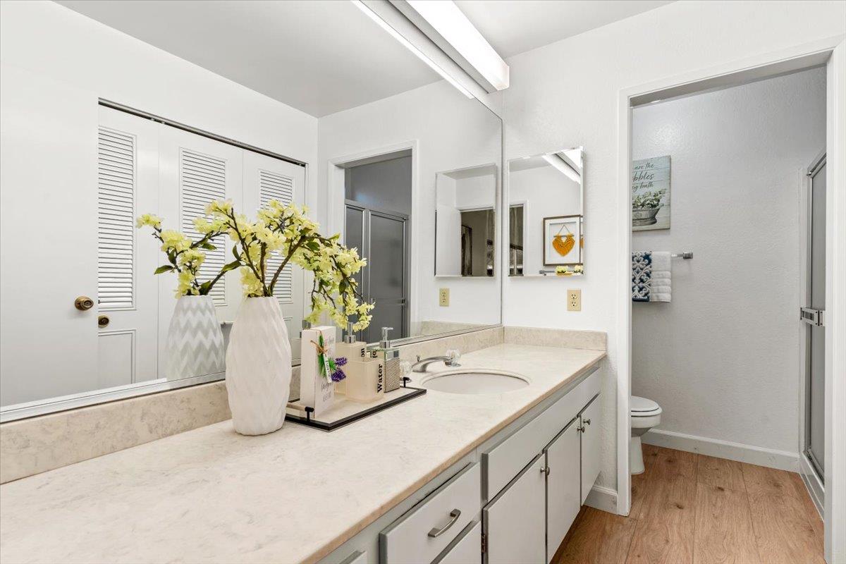 7206 Vía Lomas San Jose, CA 95139 - Photo 25 of 37 a bathroom with a granite countertop sink a mirror and a shower