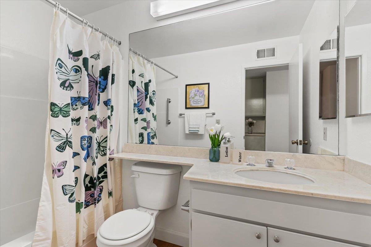 7206 Vía Lomas San Jose, CA 95139 - Photo 26 of 37 a bathroom with a toilet sink and shower curtain