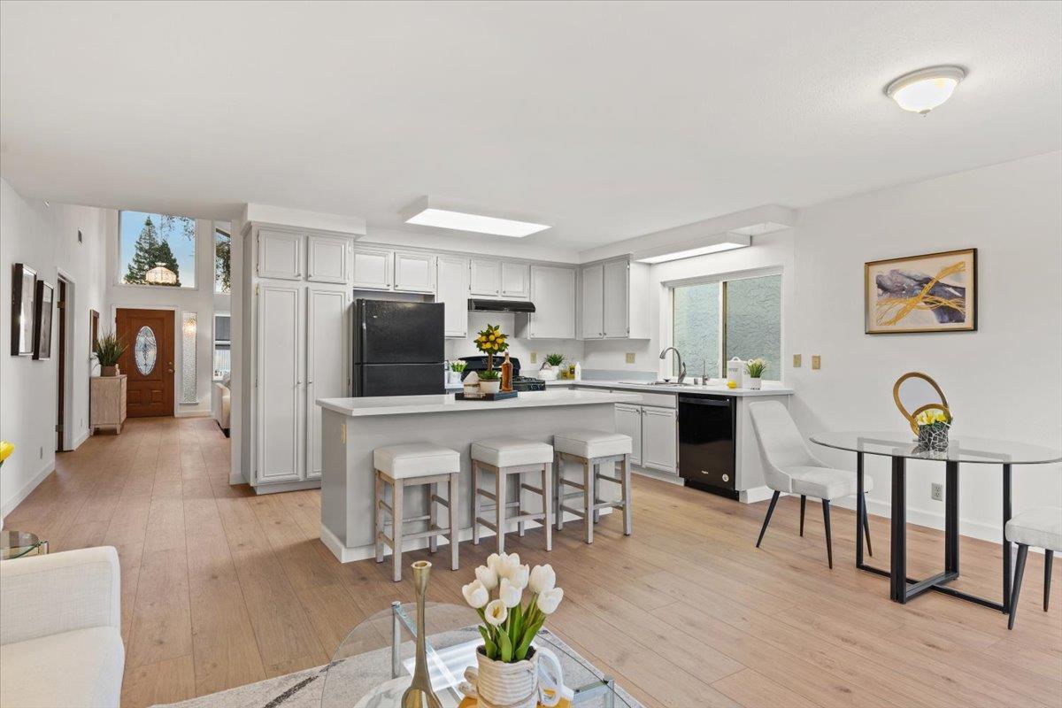 7206 Vía Lomas San Jose, CA 95139 - Photo 10 of 37 a kitchen with stainless steel appliances granite countertop a dining table chairs and chandelier