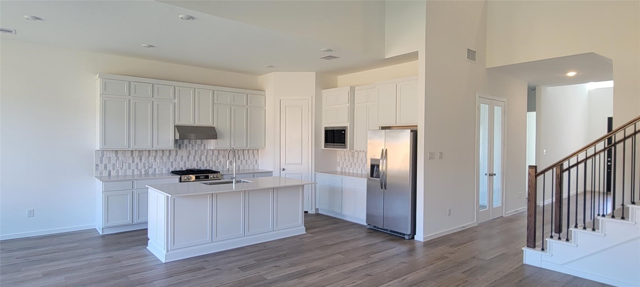 8303 Holly Blue Drive Rosharon, TX 77583 - Photo 7 of 34 a kitchen with stainless steel appliances a refrigerator sink and stove