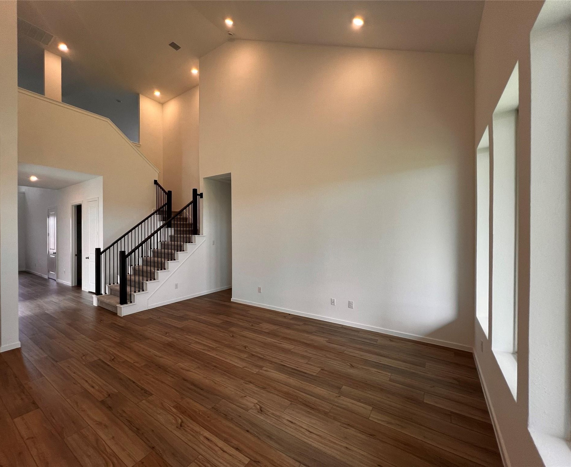 8303 Holly Blue Drive Rosharon, TX 77583 - Photo 9 of 34 a view of an empty room with wooden floor and stairs