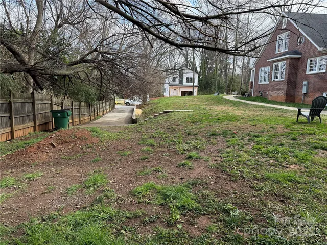 a view of a yard with a house and a tree