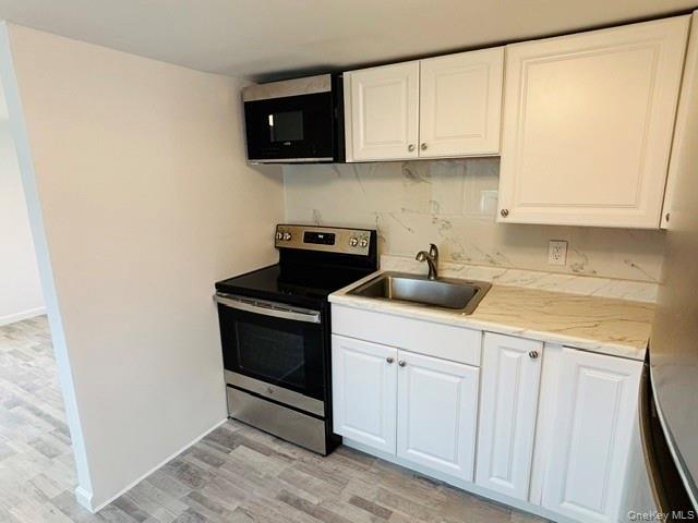 280 Hall Hill Road Ancram, NY 12502 - Photo 14 of 19 a kitchen with a sink and cabinets